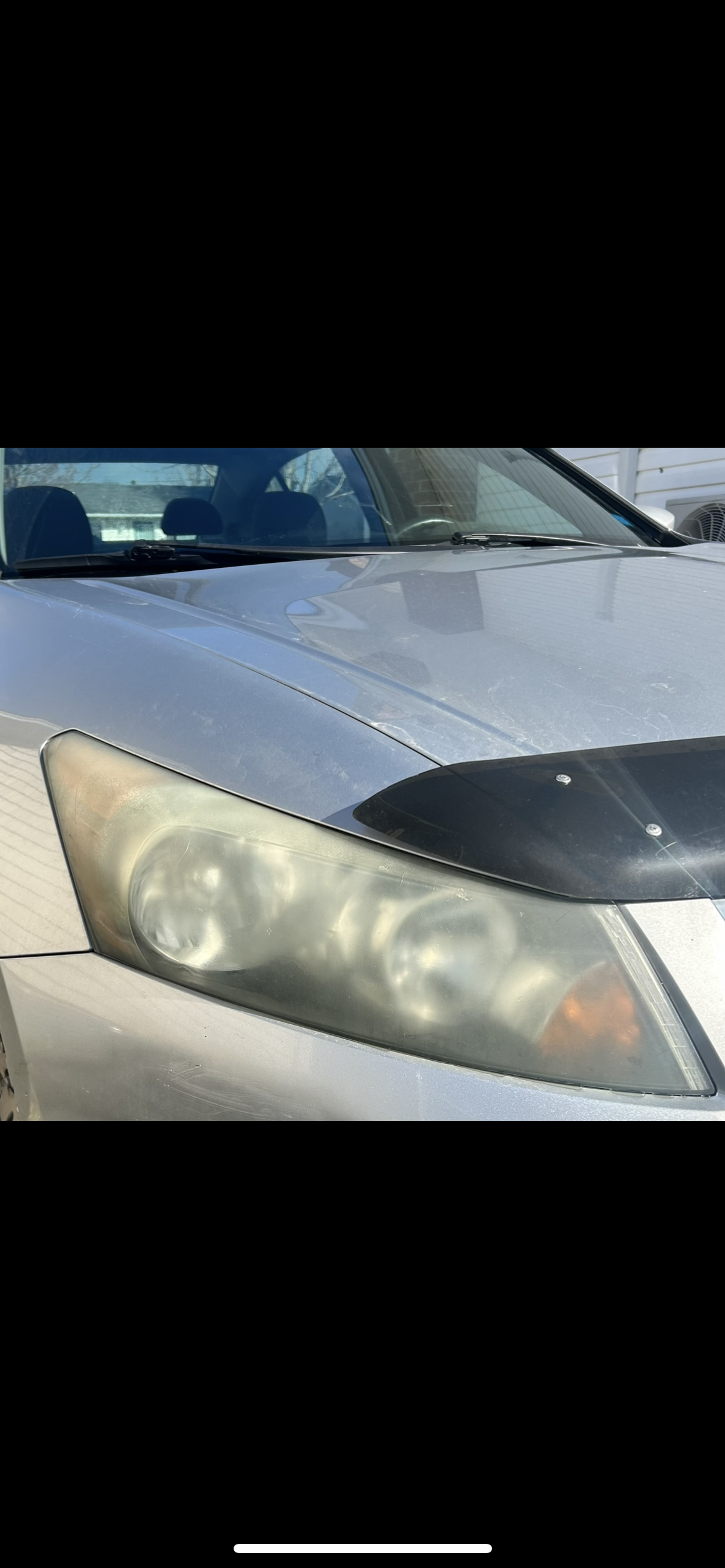 Oxidized foggy headlight before restoration on silver Honda Accord