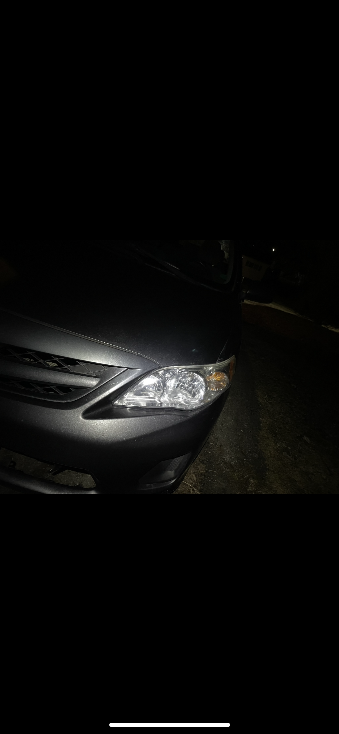 Bright clear headlight beam after restoration on dark Toyota Corolla at night